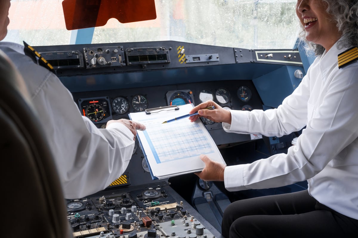 Professional pilots collaborating inside an airplane