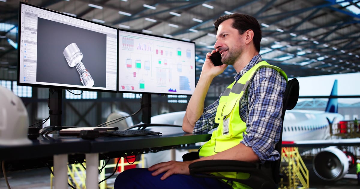 Confident business executive reviewing an operational dashboard on a tablet inside a modern corporate aviation operations center overlooking a private hangar