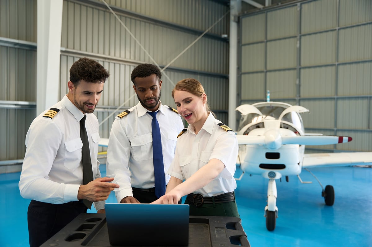 Student pilots learning in an aircraft hangar